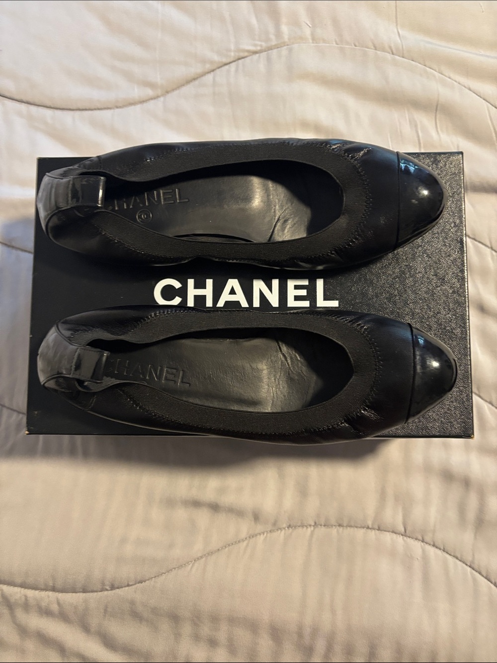 CHANEL Black Leather Ballet Flats with Patent Cap Toe